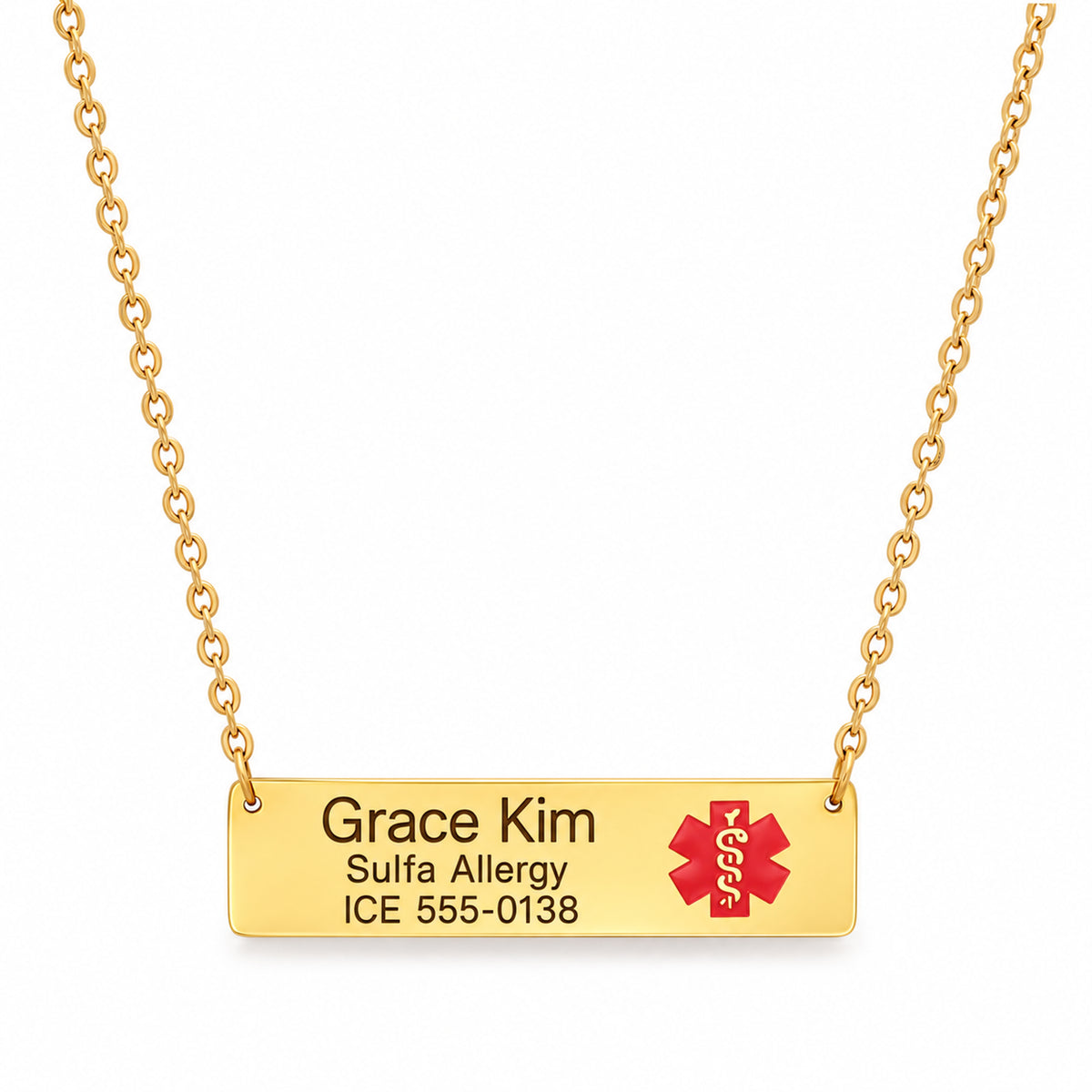 Gold-tone bar medical ID necklace with brown-black Grace Kim sample engraving and its red medical emblem.