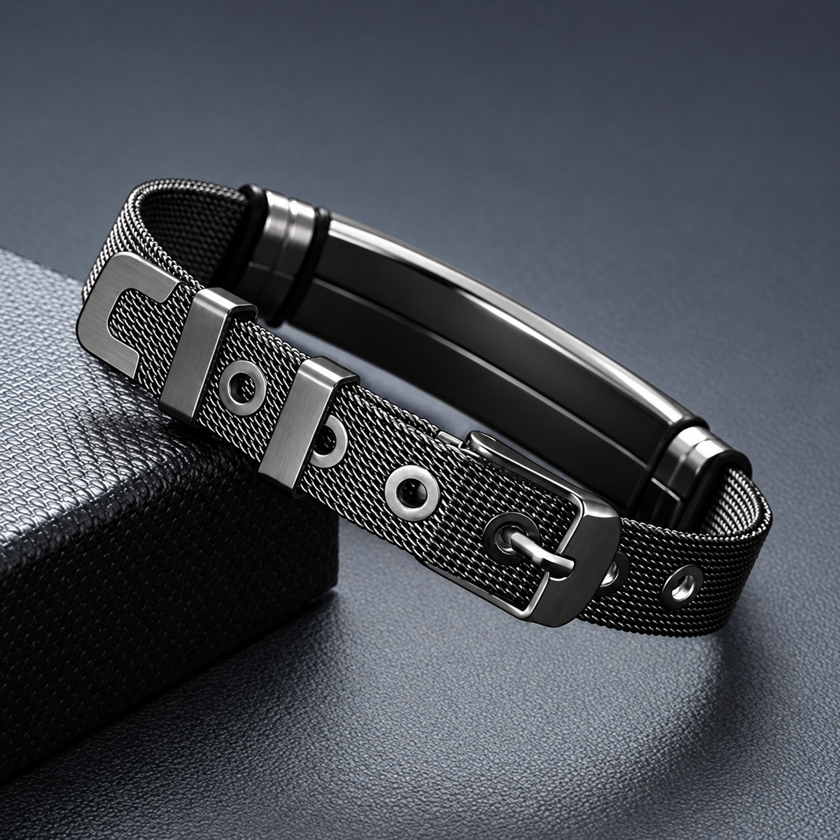 Close-up of the black metal mesh band, buckle, keeper loops and adjustment holes.